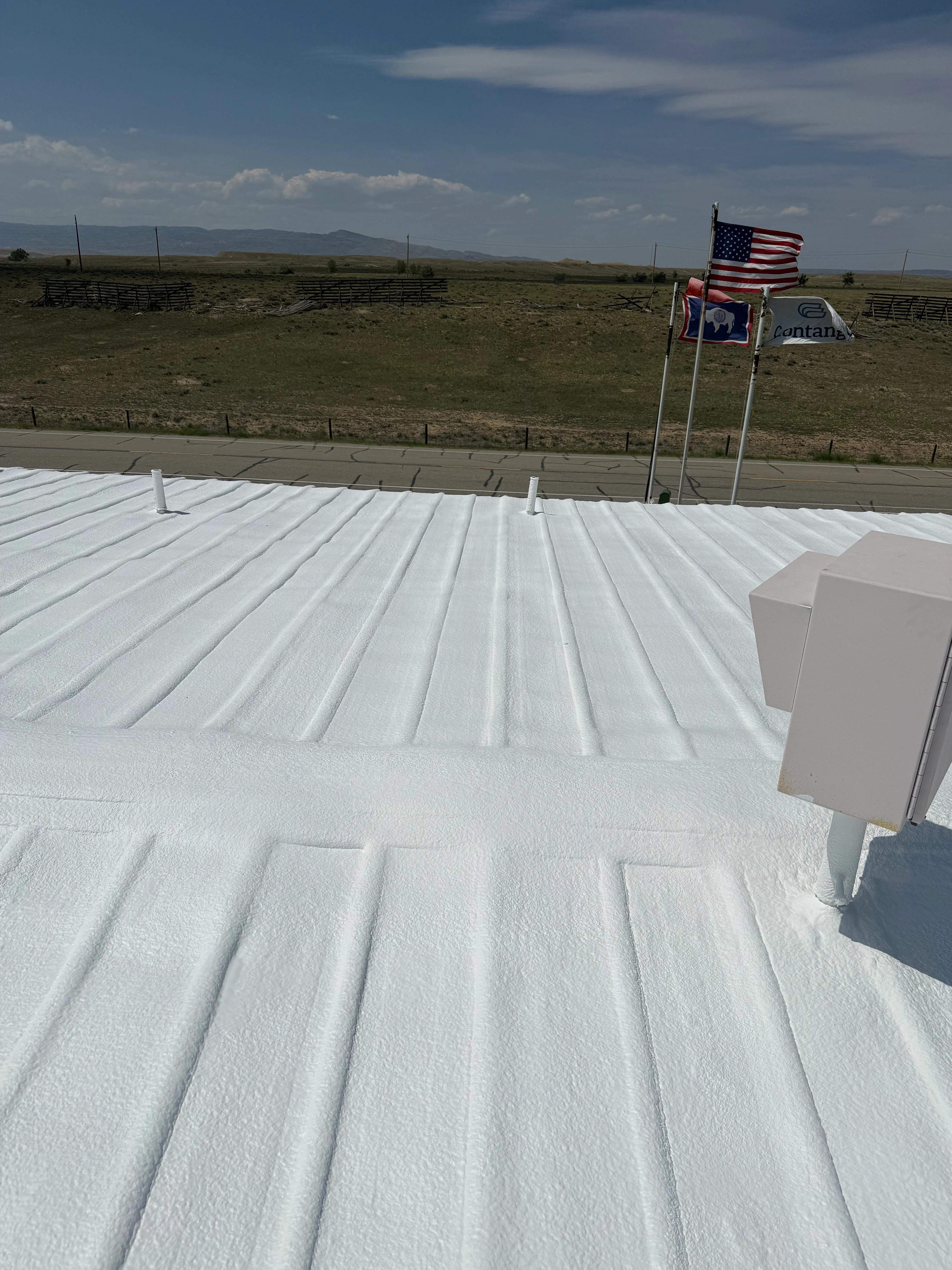 Roofer applying roofing material to residential roof