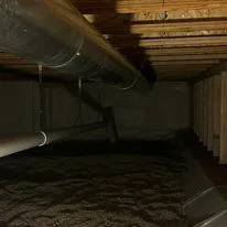 Crawlspace with spray foam insulation applied to joists and rim band