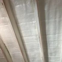 Spray foam insulation applied to ceiling joists and beams