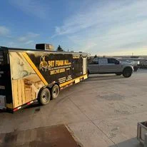 Yellow spray foam insulation equipment trailer on commercial job site in Mills, Wyoming