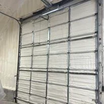 Installed foam insulation panels on residential garage door sections