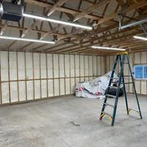 Commercial warehouse interior with foam insulation batts installed between metal studs