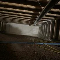 Spray foam insulation applied to commercial building ceiling and beams
