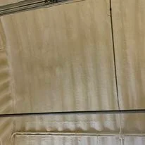 Spray foam insulation applied to interior wall framing with even coverage