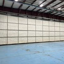 Interior of commercial warehouse with foam insulation installed on walls and ceiling