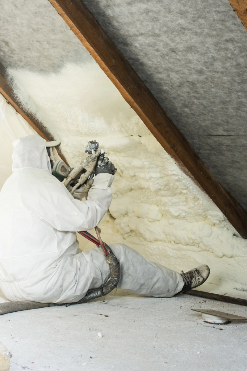 man spraying foam in an attic wall casper wy